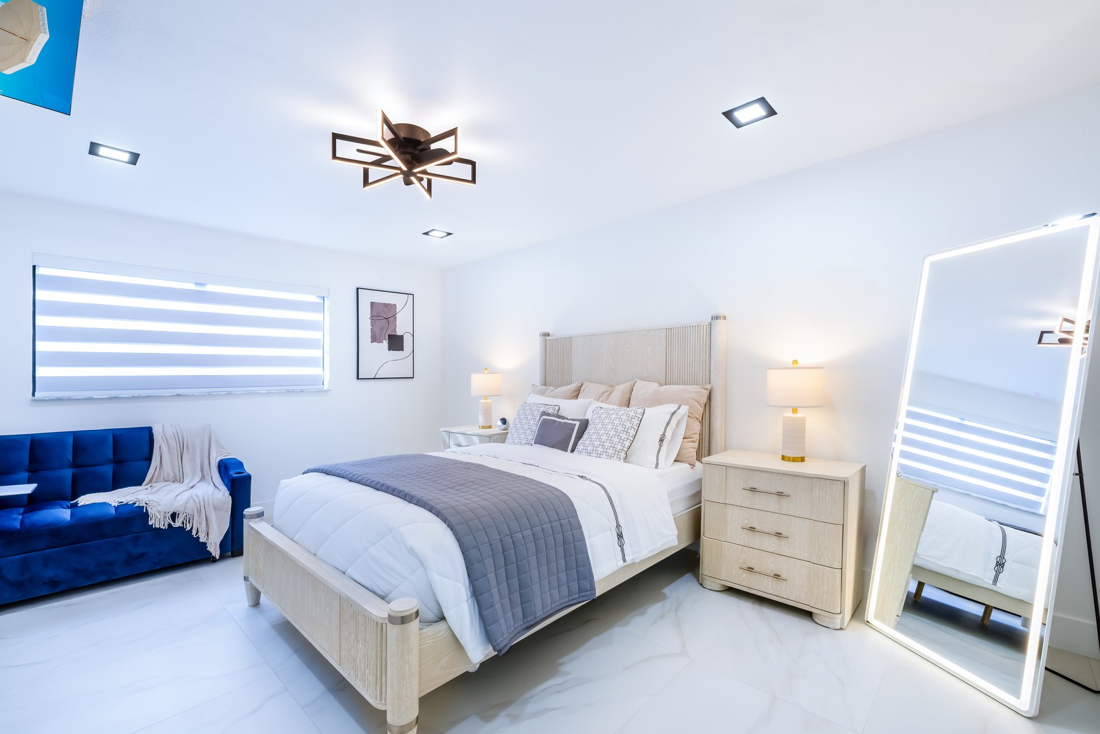 Quiet Suite with blue sofa and lit full-length mirror